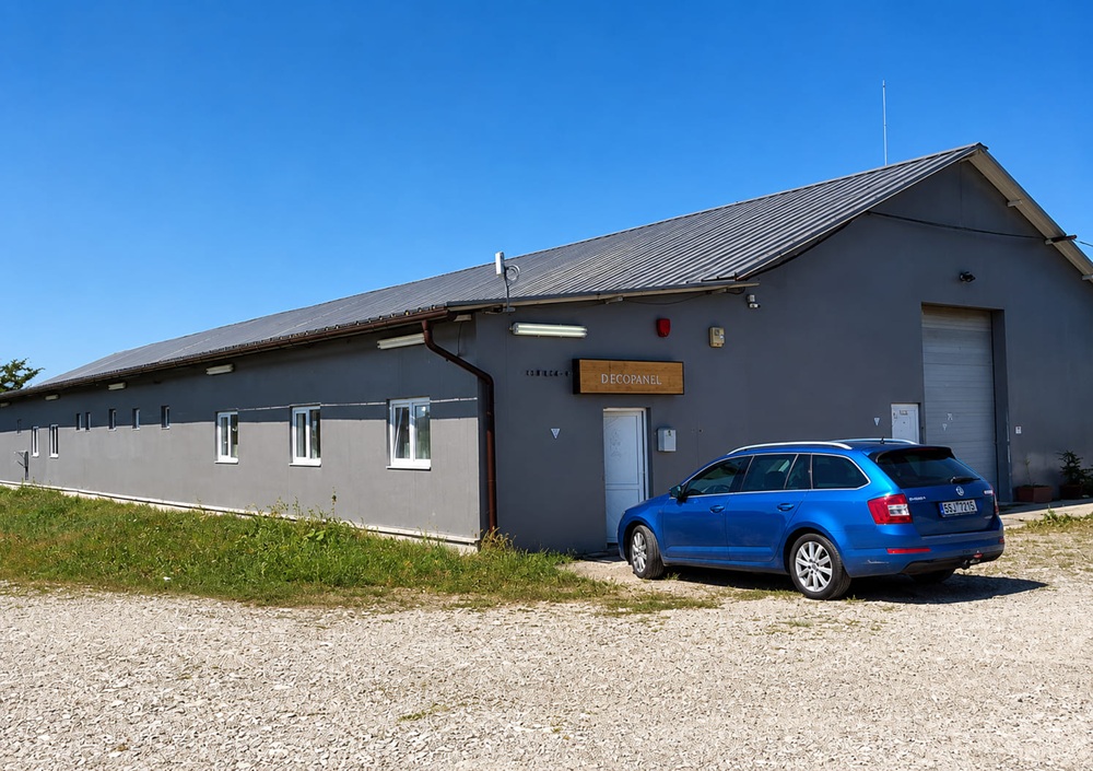 The Deco Meuble workshop building in Micești, Argeș, with the company sign above the entrance