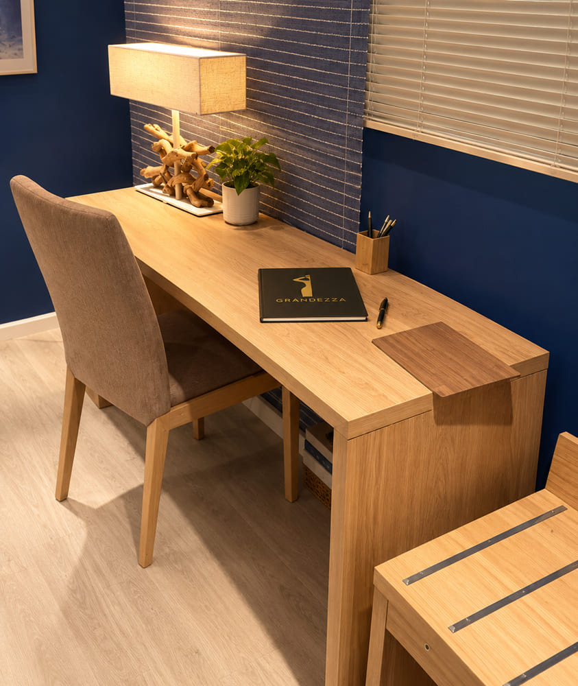 Oak hotel-room writing desk with a leather-topped pull-out and an upholstered chair
