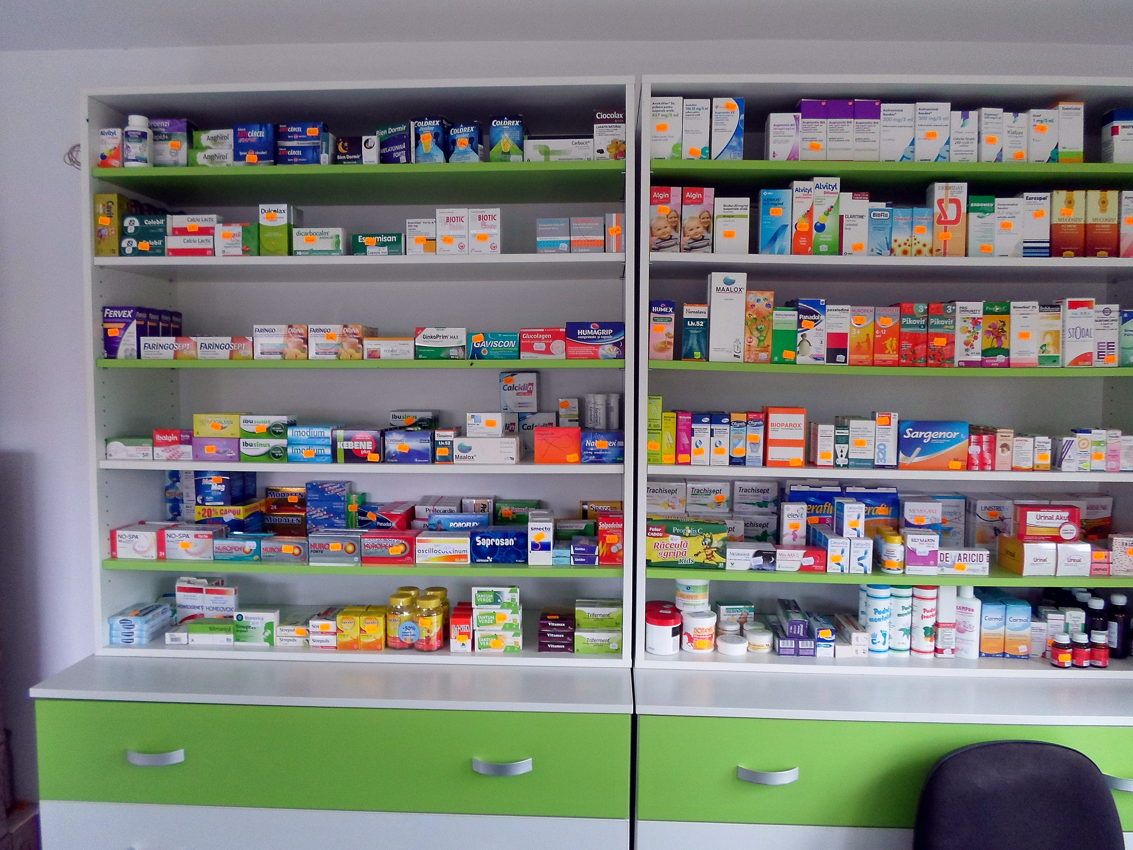 Pharmacy shelving and counter finished in white and green